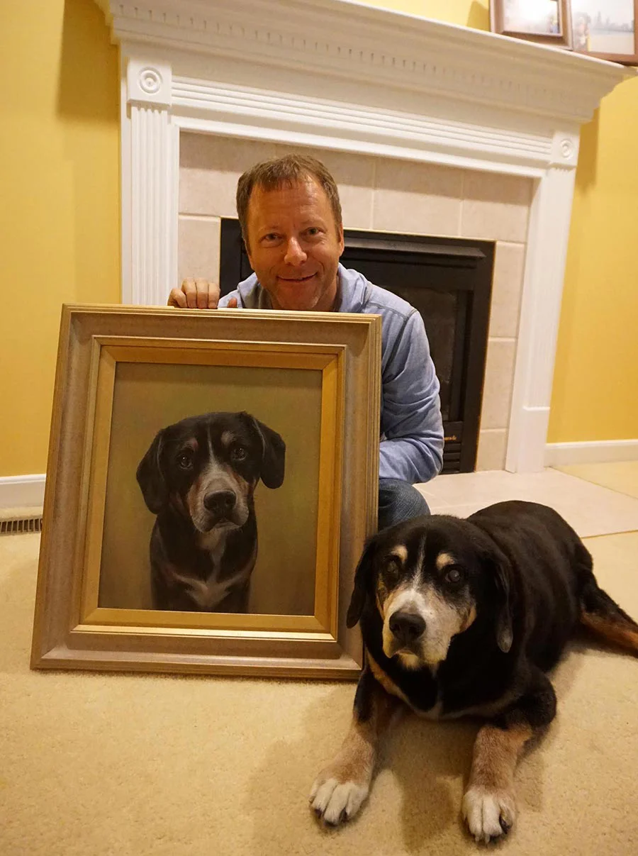 Bob the dog with his framed oil portrait and owner Lance