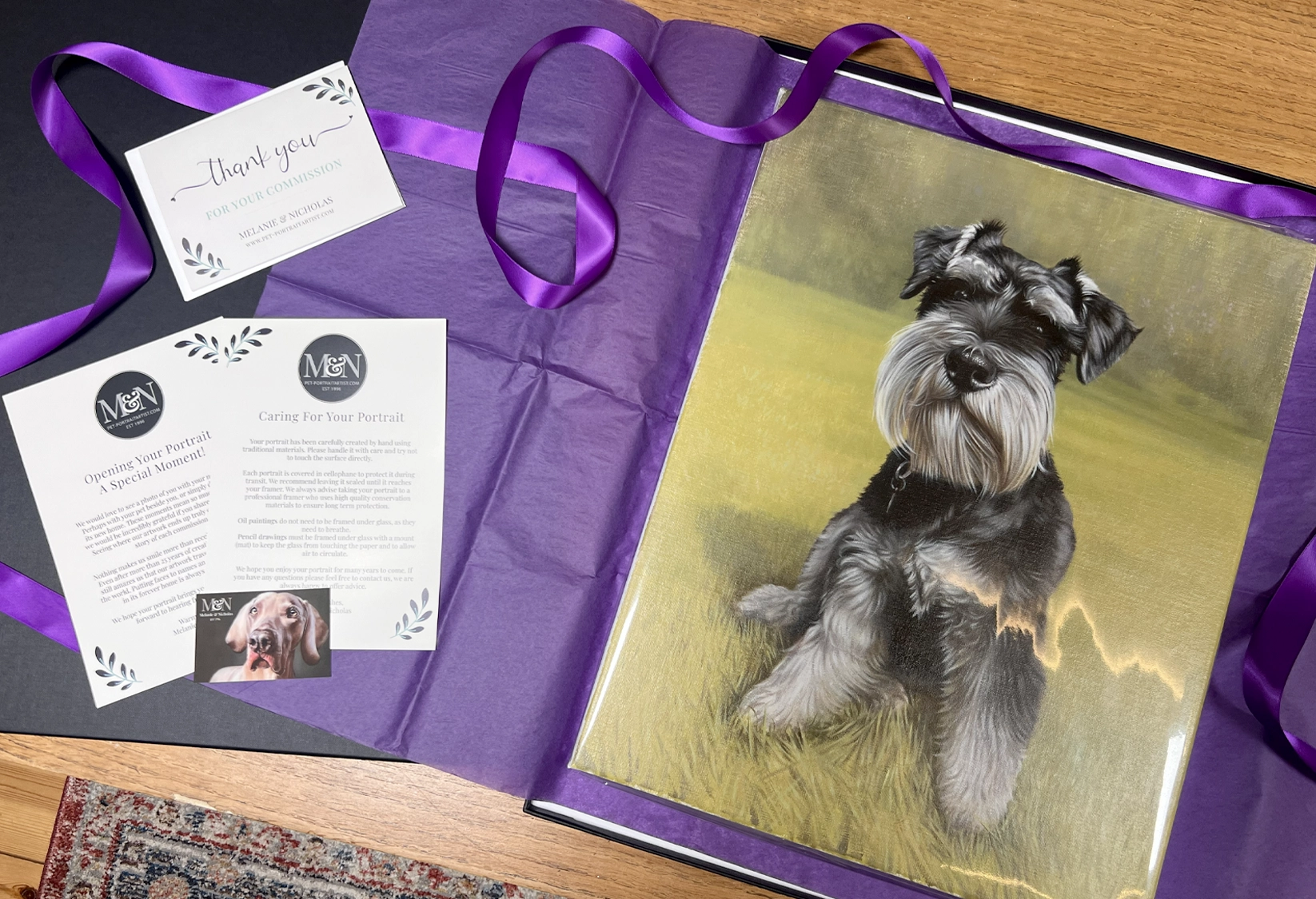 A finished oil painting of a Miniature Schnauzer packed ready to send