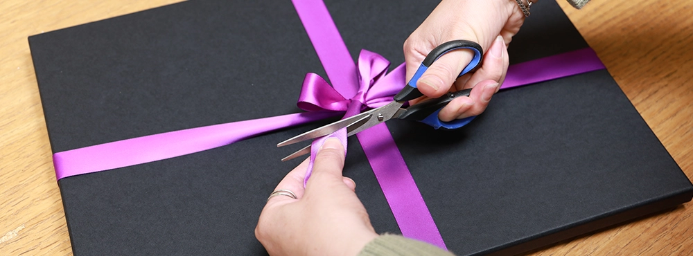 Packing a pet portrait with professional box and ribbon.
