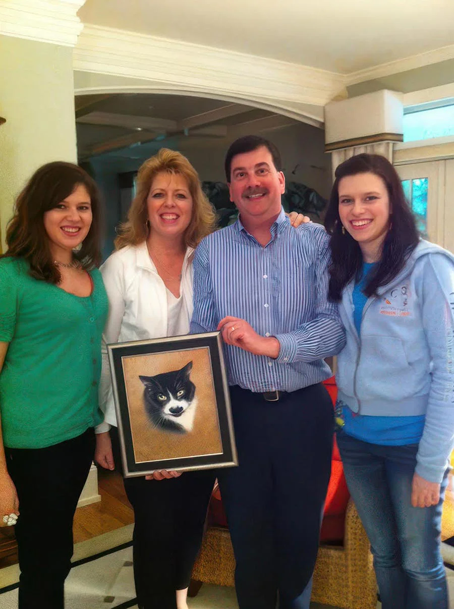 Family with memorial oil portrait of black and white cat Groucho