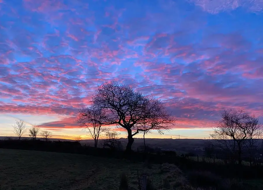 Dramatic Morning Sky for photography by Melanie Melanie Phillips photographing a dramatic and colorful morning sky, showcasing golden hour light.