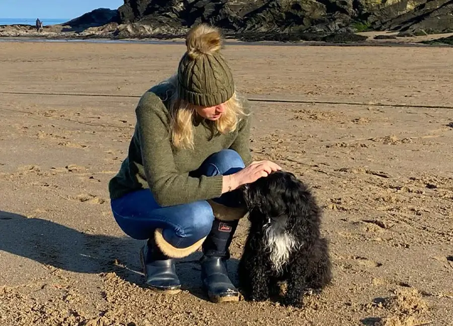 Melanie Phillips - Pet Portrait Artist Melanie Phillips smiling next to her Tibetan Terrier, Lily.