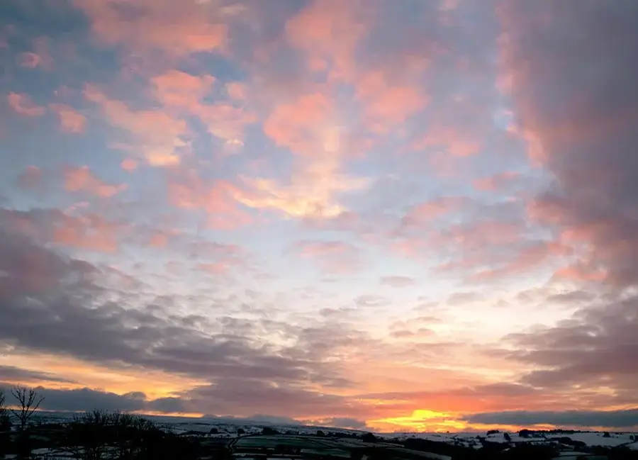 Cloudscape photography by Melanie A serene cloudscape photograph by Melanie Phillips, showing soft, layered clouds against a peaceful early morning sky.