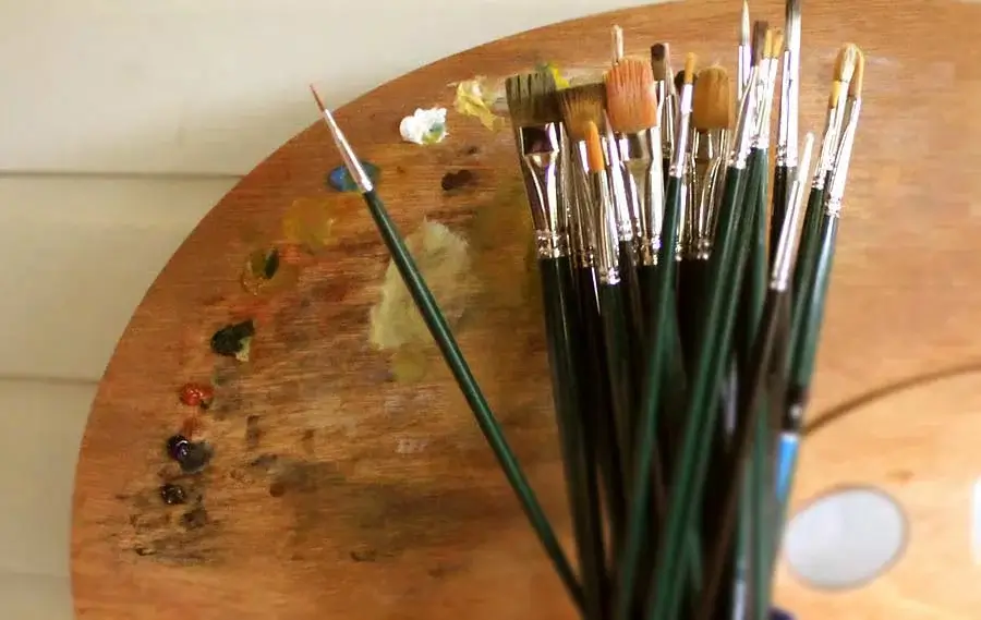 Nicholas's Painting Palette and Tools for Oil Portraits Nicholas’s well-used paint palette and a collection of brushes, showcasing the tools essential for his detailed oil pet portraits.